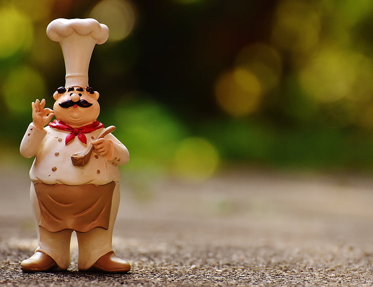 photography of selective focus male chef figurine