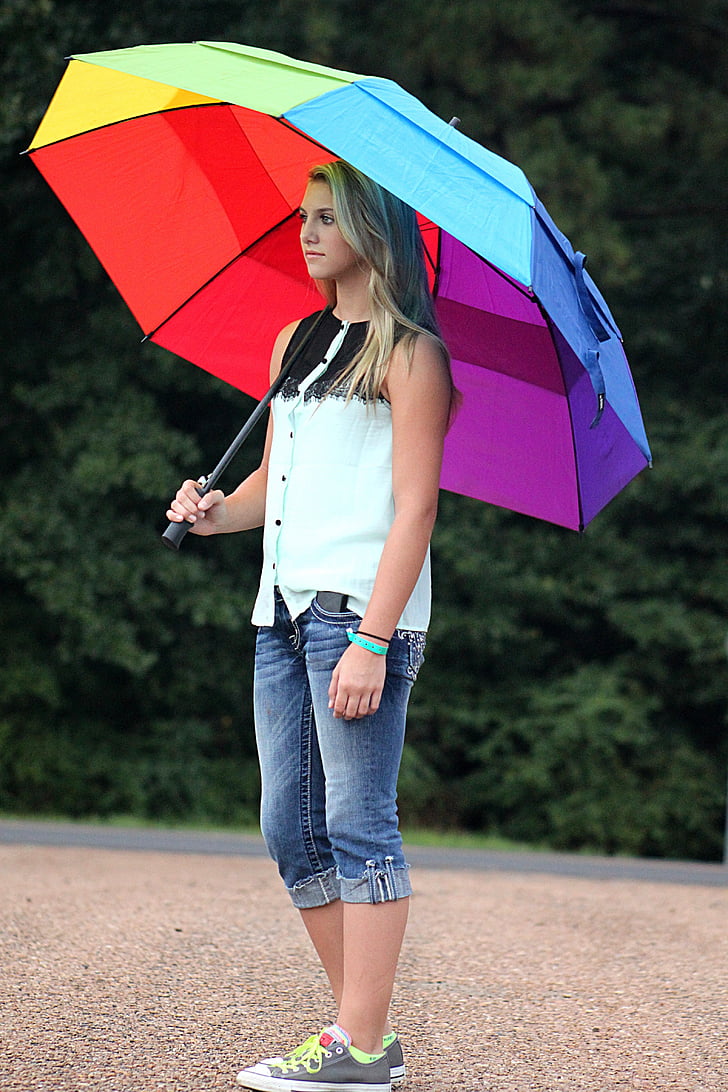 person using multicolored umbrella