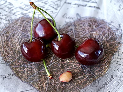 four red cherries on heart brown textile