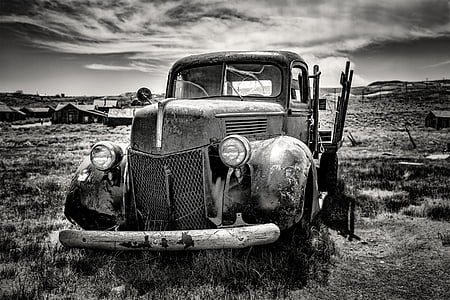 grayscale photo of single cab pickup truck on grass field