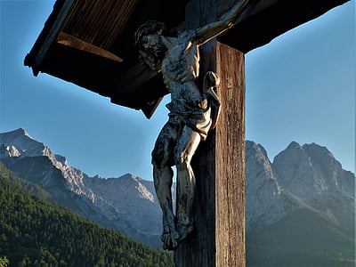 wooden cross decor near green mountain