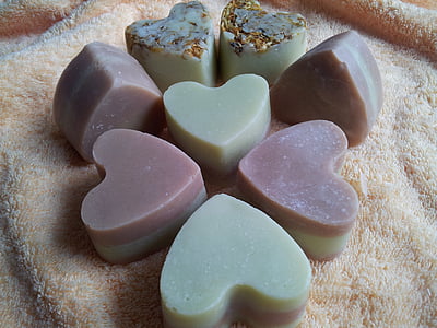 eight heart bath soaps on brown textile