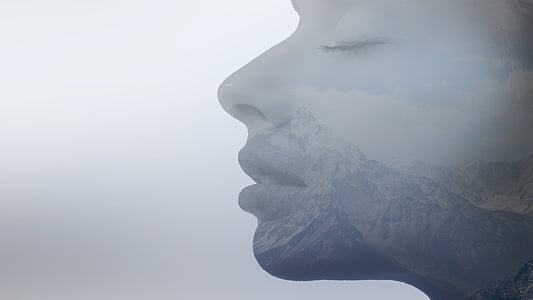 human face with snow capped mountain illustration