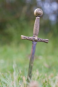 depth of field photography of sword in ground