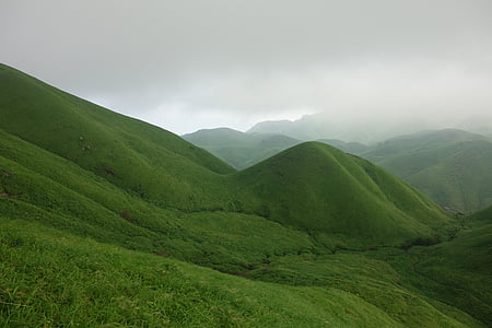 view of green hills range under gray clouds