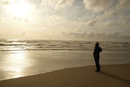 man standing in the shore