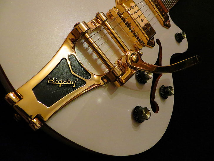 gold and white guitar