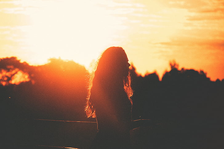 silhouette photo of woman during sunset