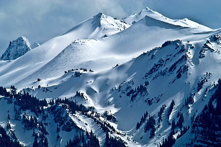 mountain coated with white snow during daytime