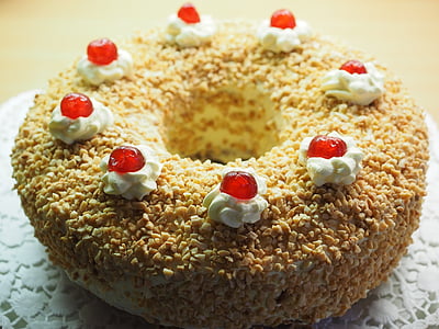 round icing covered doughnut with nuts