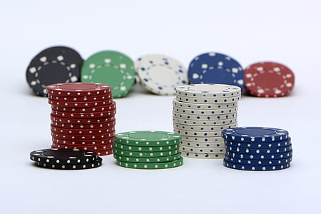 assorted-color poker chips on white surface