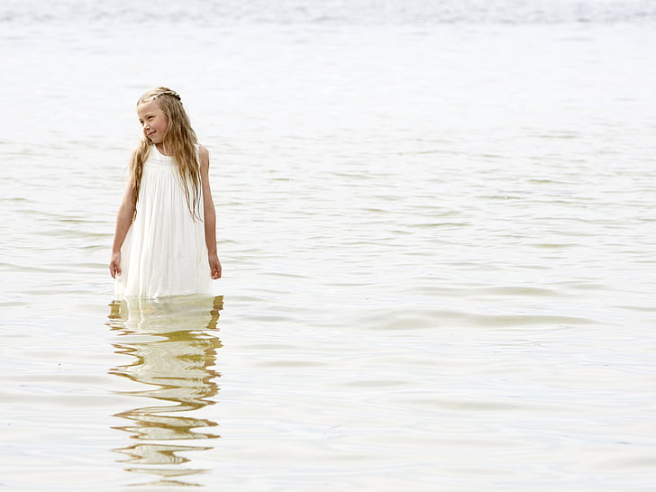 photo of girl in white dress in body of water