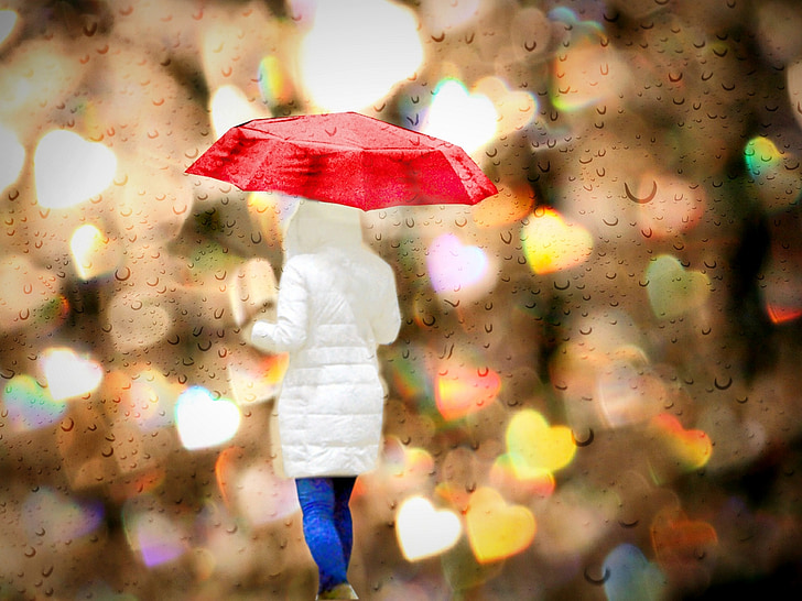 person wearing white jacket and holding umbrella