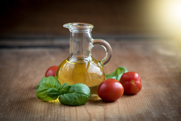 oil in vial near tomatoes