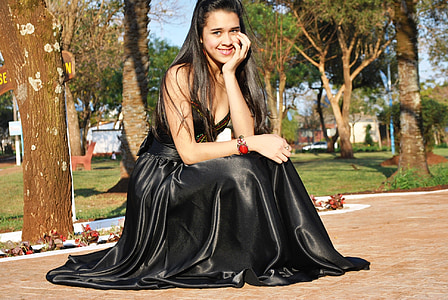 woman wearing black silk sleeveless dress