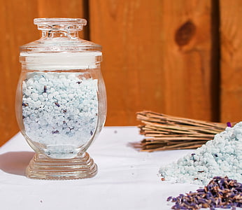 clear glass jar filled with teal pebbles