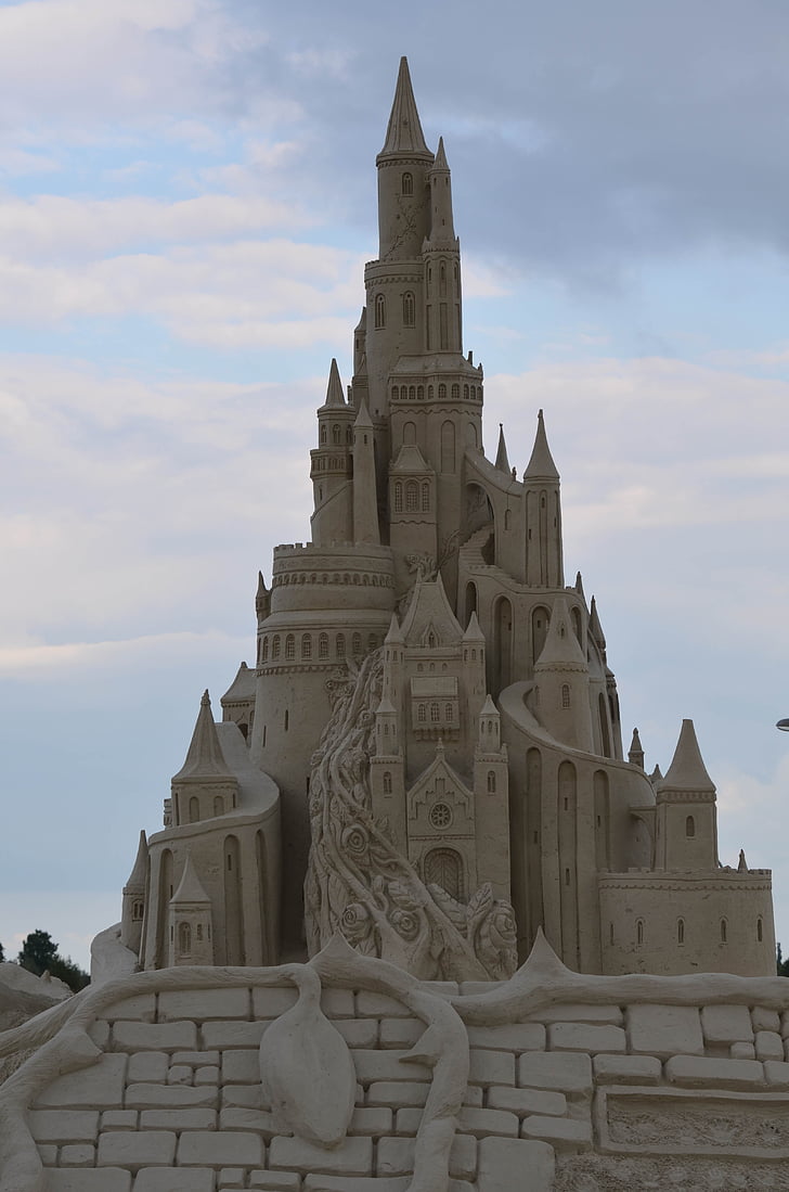 brown sand castle under cloudy sky during daytime