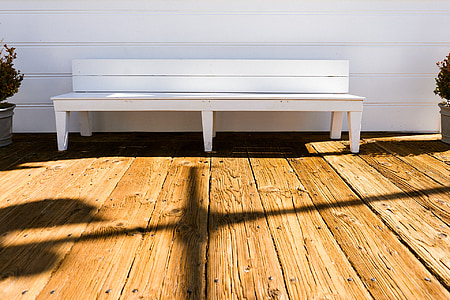 white wooden bench near white wall