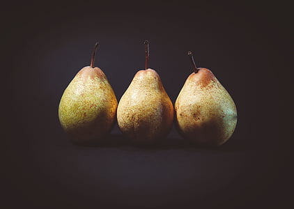 three pears with black background