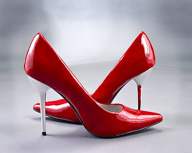 closeup photo of red-and-white leather stiletto shoes