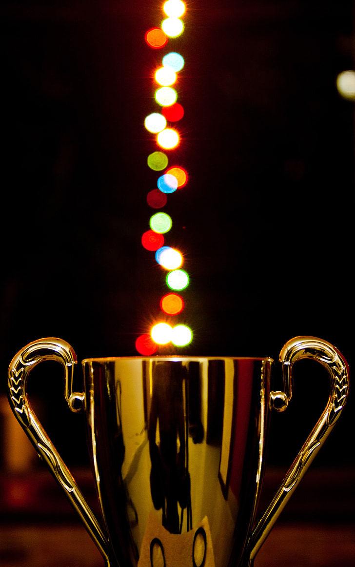 gold trophy figure with bokeh effect