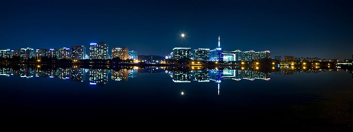 body of water near building at nighttime