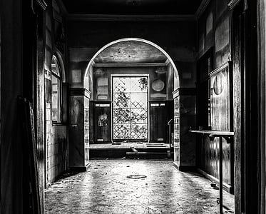 grayscale photo of hallway inside closed room