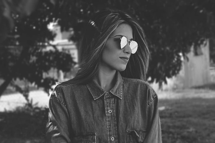 greyscale photography of woman wearing sunglasses