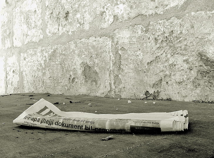 newspaper on gray concrete floor