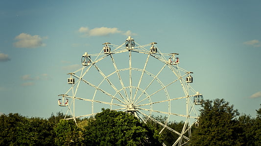photo of white Ferris wheel under blue sky background