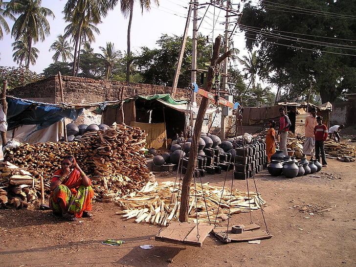firewood and clay pot piled outside the house