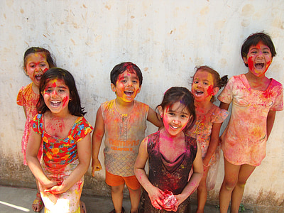 group of children wearing paint standing near wall