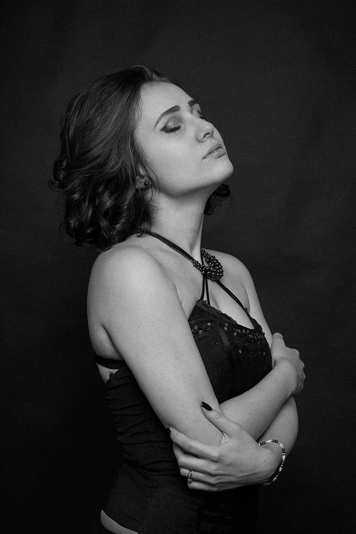 grayscale photography of woman wearing spaghetti-strap top