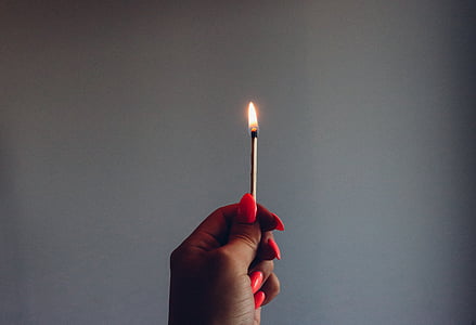 person holding a burning matchstick