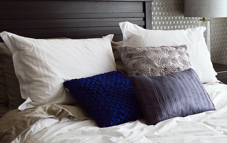 assorted-color pillows on bed