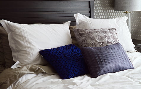 assorted-color pillows on bed