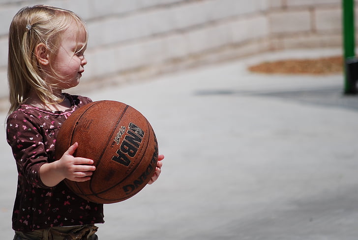 girl carrying basketball