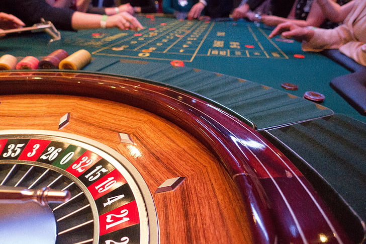 people surrounding poker table