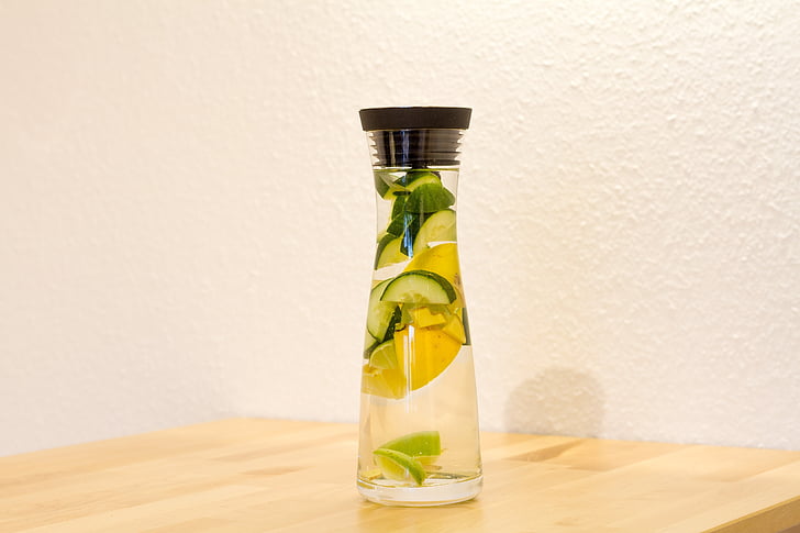 clear glass bottle with water and citrus