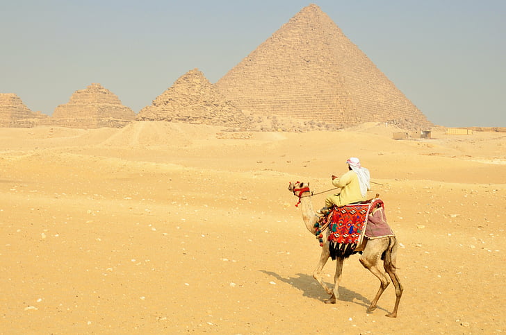 man riding camel near Pyramids of Giza in Egypt