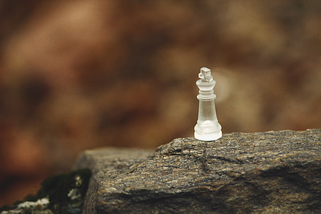 clear glass chess piece in selective focus photography