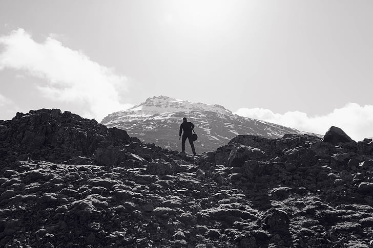 man silhouette on top of mountain