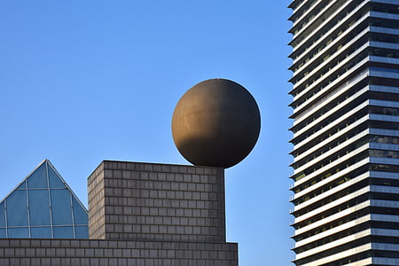 black ball on gray concrete building during daytime