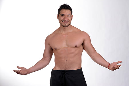 topless man smiling wearing black bottoms