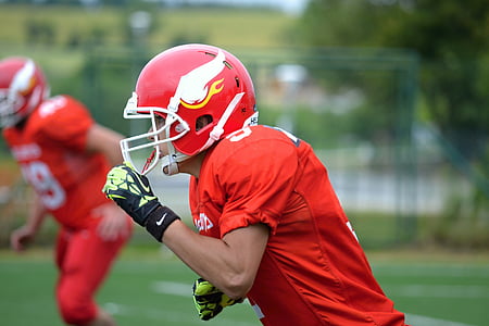 man in red football shirt and helmet