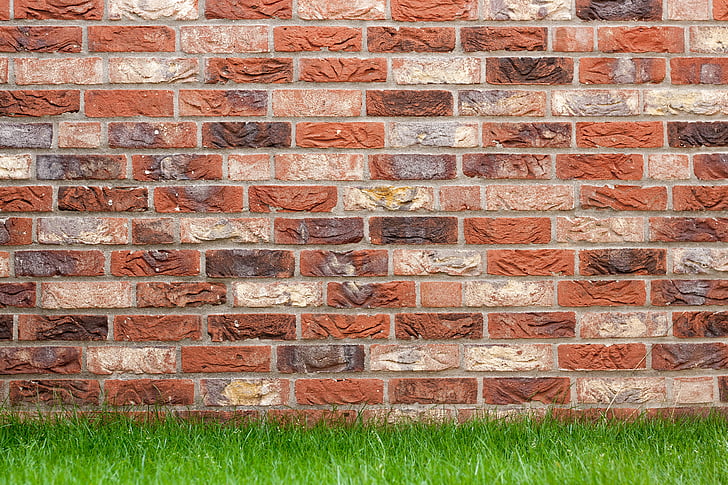 brown brick wall and green grass