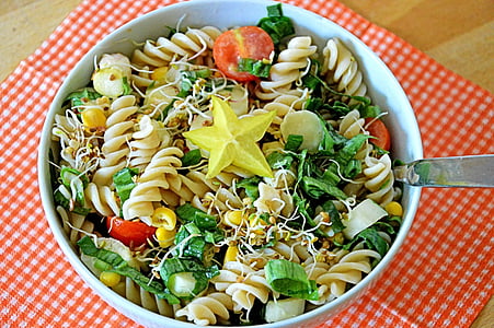 pasta with vegetables in round white ceramic bowl