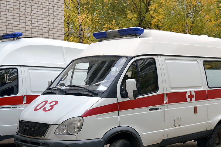 white and red ambulance van