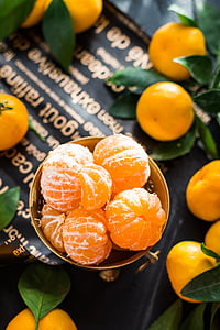closeup photo of orange fruits on gray bowl
