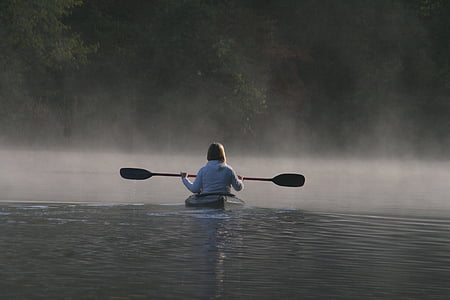 person in white jacket using a boat